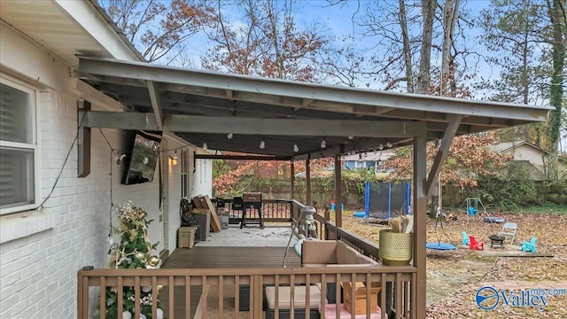 wooden deck featuring a trampoline