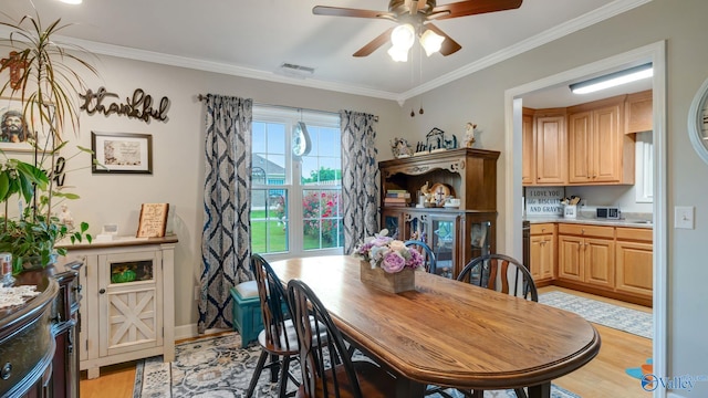 112 Bullard Rd, Hazel Green, AL 35750 - dining area featuring light wood-type flooring, ceiling fan, crown molding, and baseboards