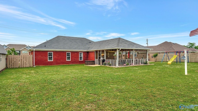 112 Bullard Rd, Hazel Green, AL 35750 - rear view of property featuring a playground, a patio, brick siding, and a shingled roof