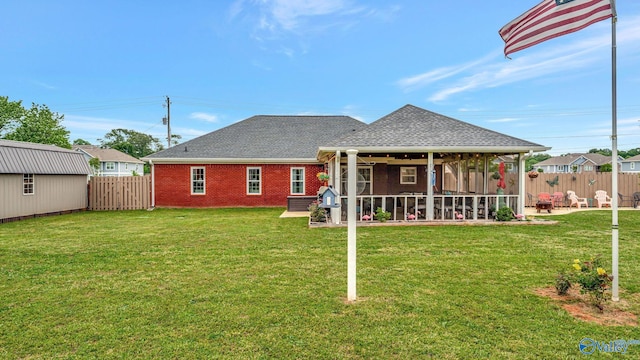 112 Bullard Rd, Hazel Green, AL 35750 - rear view of house featuring a sunroom, a patio area, roof with shingles, and brick siding