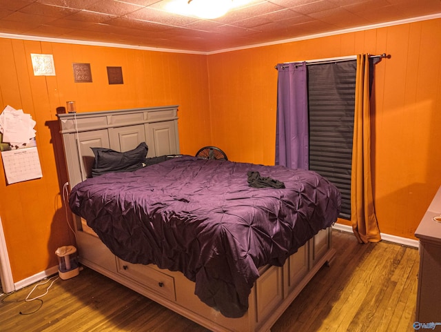 bedroom with hardwood / wood-style floors and ornamental molding