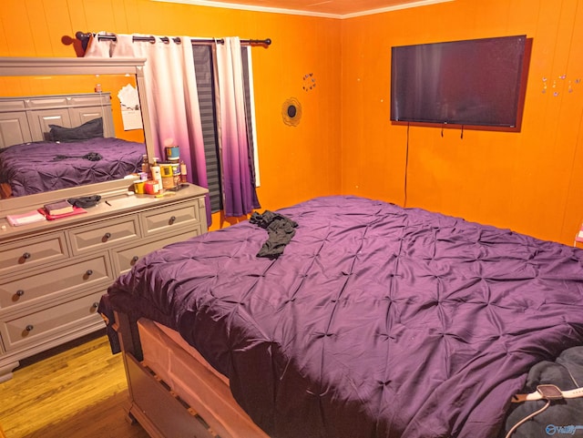 bedroom with crown molding and light hardwood / wood-style flooring