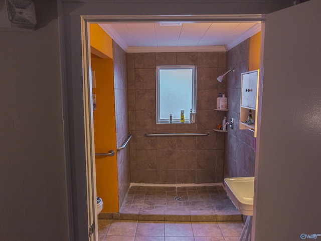 bathroom with ornamental molding, tiled shower, tile patterned floors, and toilet