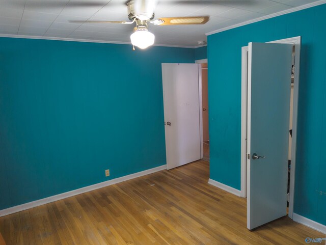 unfurnished bedroom featuring hardwood / wood-style flooring, ceiling fan, and ornamental molding