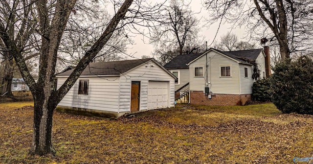 exterior space with a garage and an outdoor structure