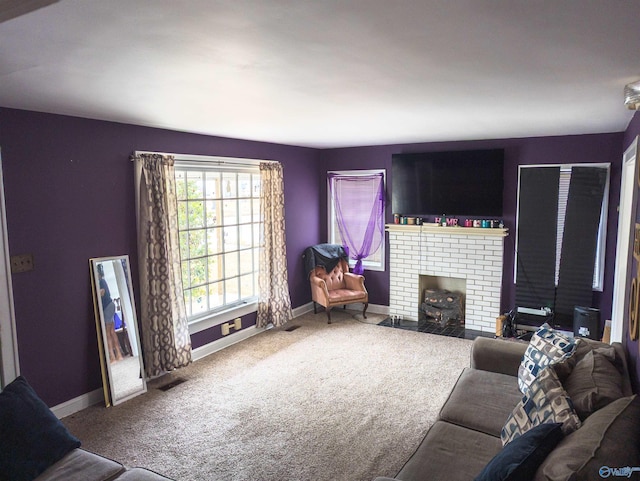 living room with carpet flooring and a brick fireplace