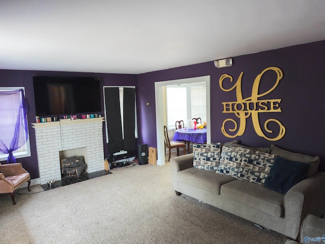 living room with a brick fireplace and carpet flooring