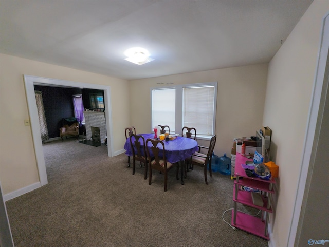 carpeted dining area with a fireplace