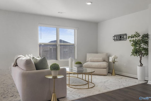 sitting room with dark wood-type flooring