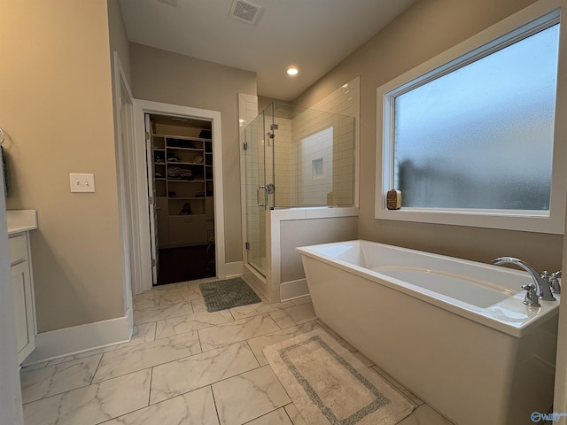 bathroom with vanity and separate shower and tub