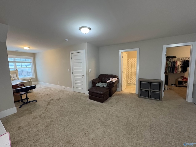 sitting room featuring light colored carpet