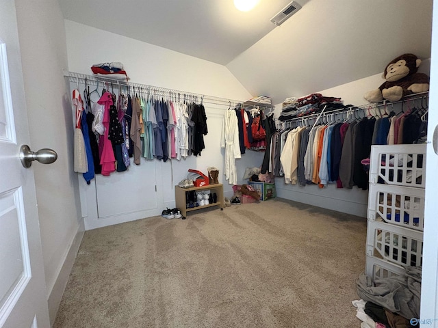 walk in closet featuring lofted ceiling and carpet flooring