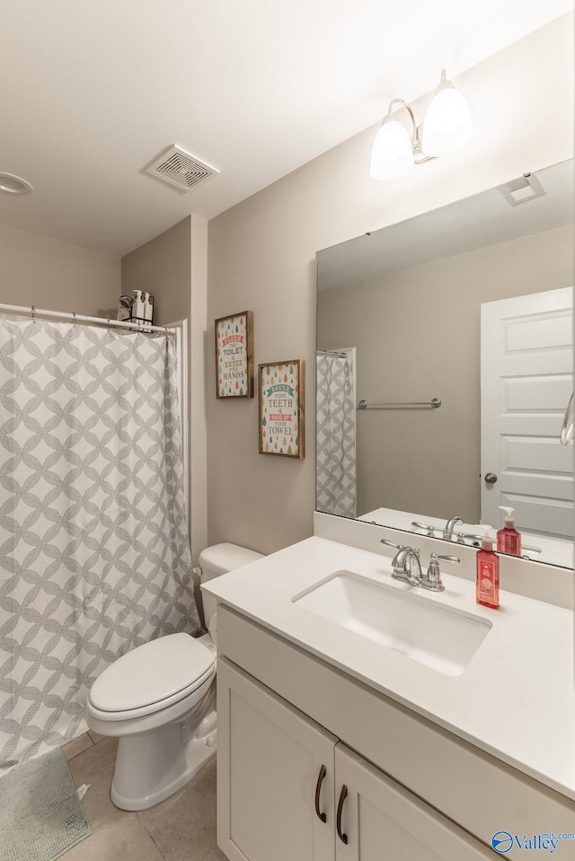 bathroom with vanity, tile patterned floors, and toilet