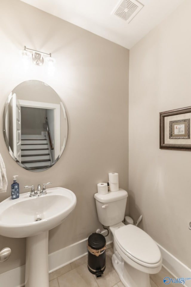 bathroom with tile patterned flooring and toilet