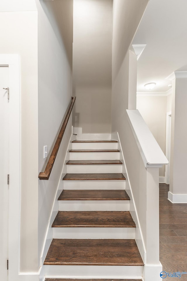 stairs featuring hardwood / wood-style floors and ornamental molding