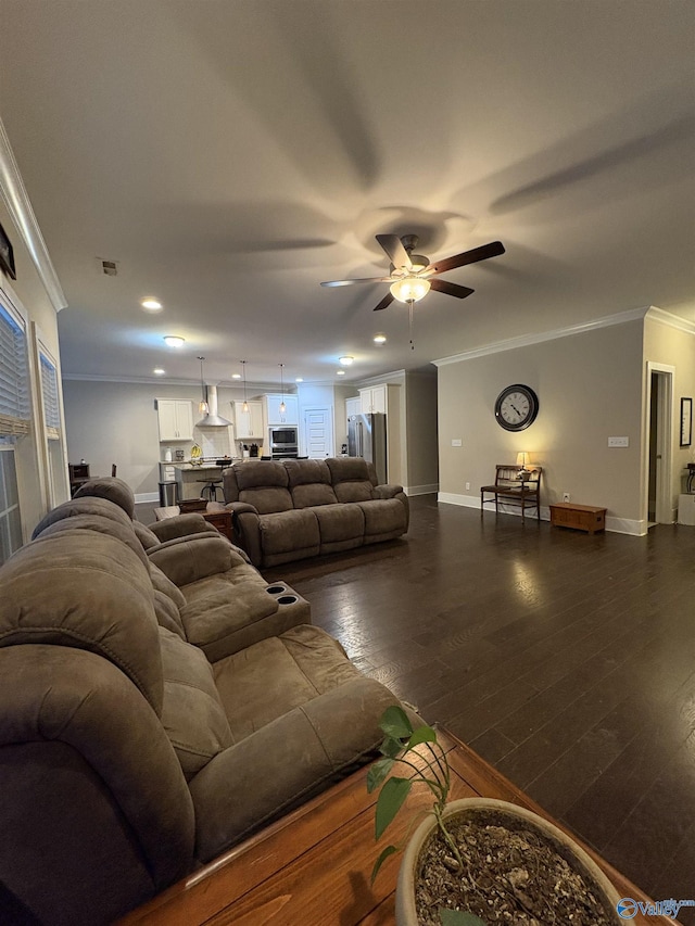 living room with crown molding, ceiling fan, and dark hardwood / wood-style floors