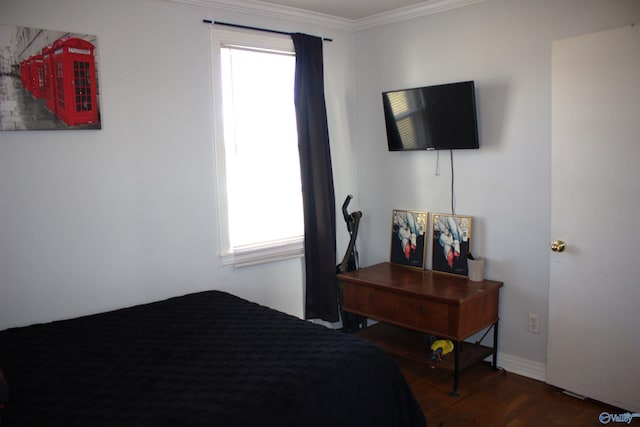 bedroom featuring multiple windows, ornamental molding, and dark wood-type flooring