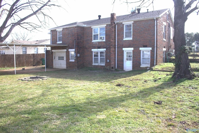 rear view of property featuring a yard and a garage