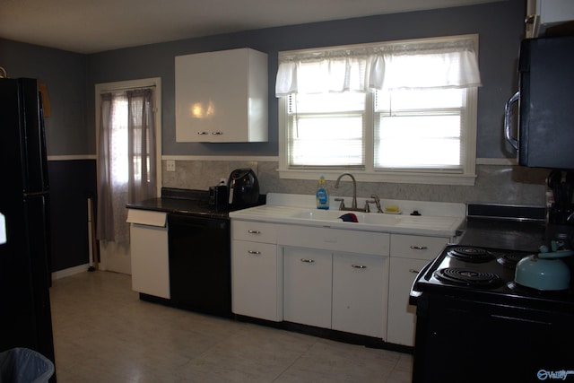 kitchen with backsplash, black appliances, sink, and white cabinets