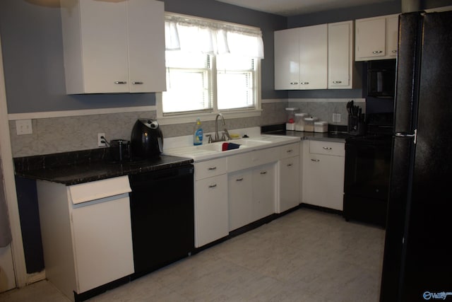 kitchen featuring white cabinets, sink, decorative backsplash, and black appliances