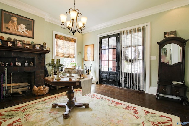 dining area featuring a fireplace, ornamental molding, a chandelier, and wood finished floors