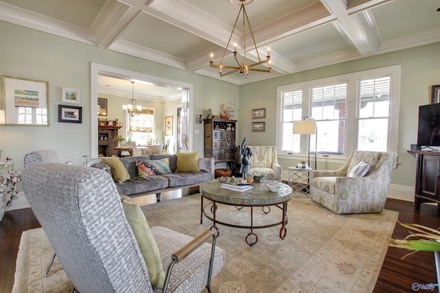 living room featuring coffered ceiling, plenty of natural light, wood finished floors, and an inviting chandelier