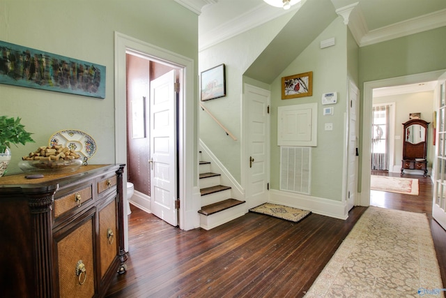 entryway with dark wood-style flooring, visible vents, crown molding, and stairs