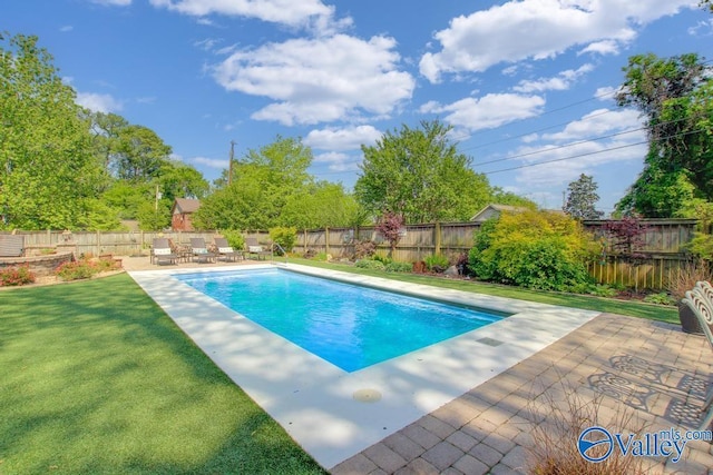 view of swimming pool featuring a yard, a fenced backyard, a fenced in pool, and a patio