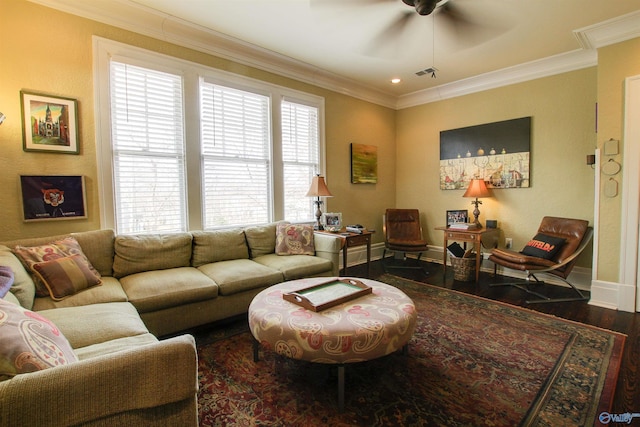 living area featuring visible vents, crown molding, baseboards, and wood finished floors