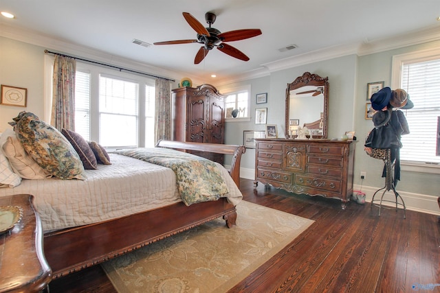 bedroom featuring baseboards, visible vents, wood finished floors, and ornamental molding