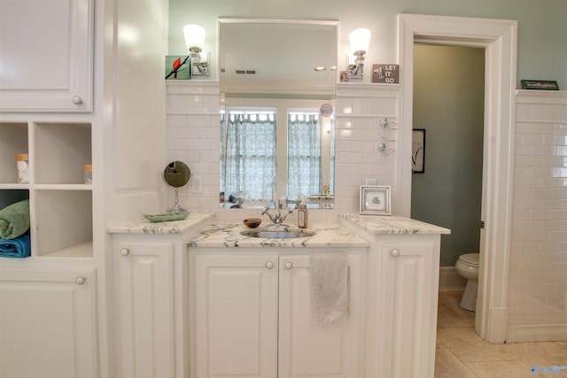 bathroom with visible vents, vanity, toilet, and tile patterned floors