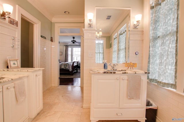 full bath featuring ornamental molding, visible vents, connected bathroom, and tile walls