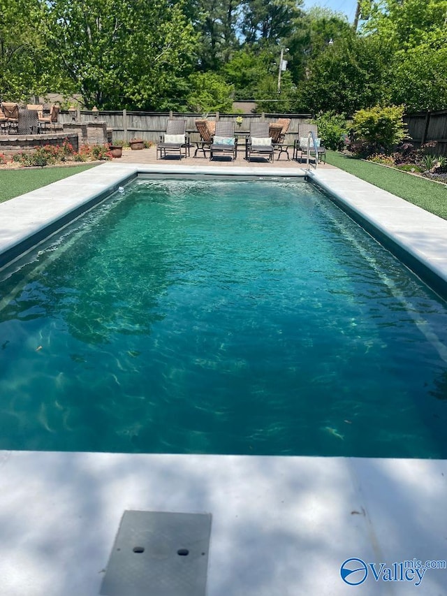 view of pool featuring a fenced in pool, a fenced backyard, and a patio