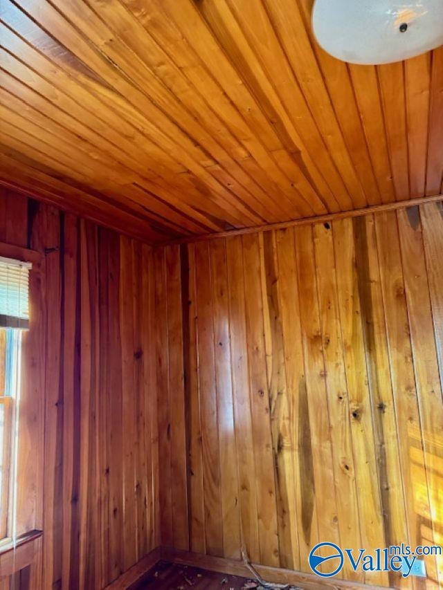 spare room with wooden ceiling and wood walls