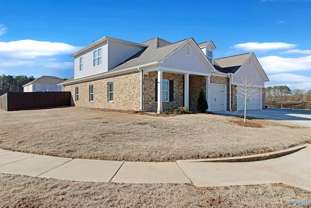 view of front of home featuring an attached garage, fence, concrete driveway, and brick siding