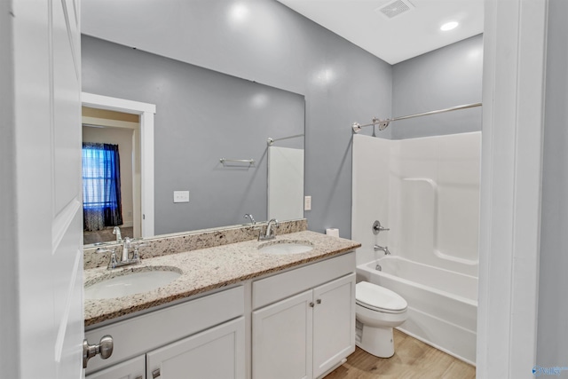 full bathroom featuring visible vents, a sink, toilet, and double vanity