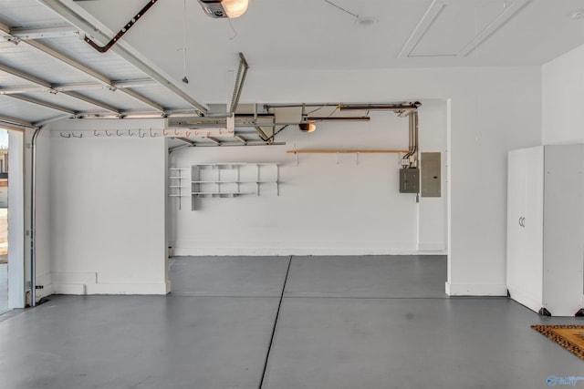 garage with a garage door opener, electric panel, and baseboards