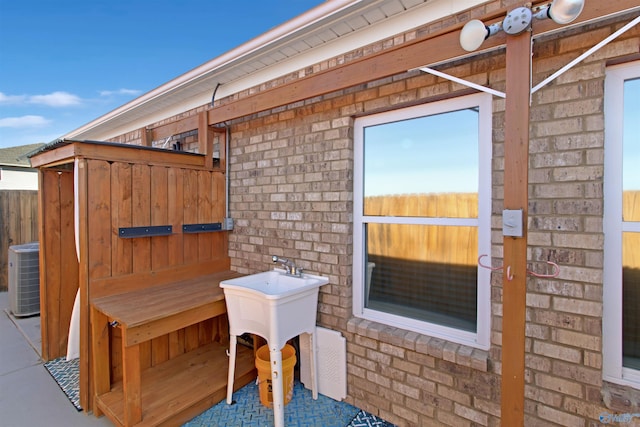 view of patio featuring fence and cooling unit