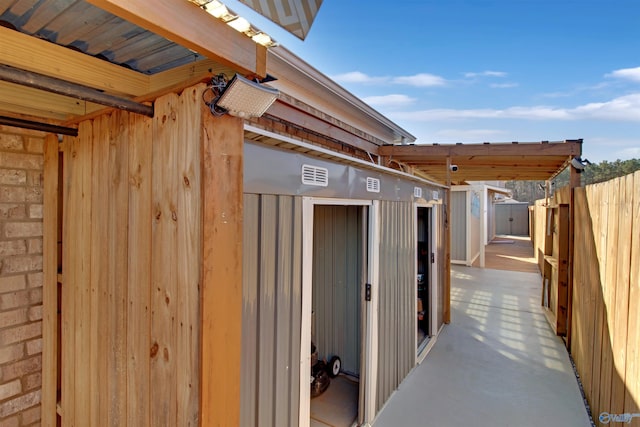 view of outbuilding featuring fence