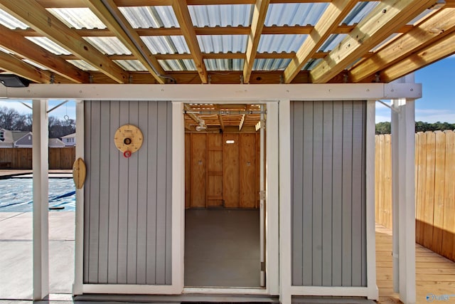 exterior space with fence and metal roof