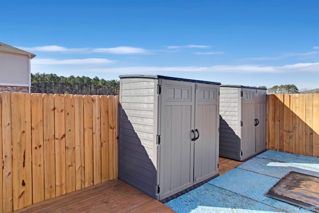 view of shed featuring fence