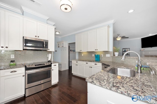 119 Autumn Cove Dr, Madison, AL 35756 - kitchen with appliances with stainless steel finishes, ornamental molding, tasteful backsplash, dark wood-style flooring, and light stone counters