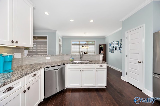 119 Autumn Cove Dr, Madison, AL 35756 - kitchen with appliances with stainless steel finishes, a peninsula, decorative backsplash, white cabinetry, and light stone counters