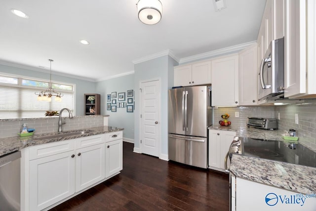 119 Autumn Cove Dr, Madison, AL 35756 - kitchen featuring appliances with stainless steel finishes, backsplash, crown molding, white cabinetry, and dark wood-style floors