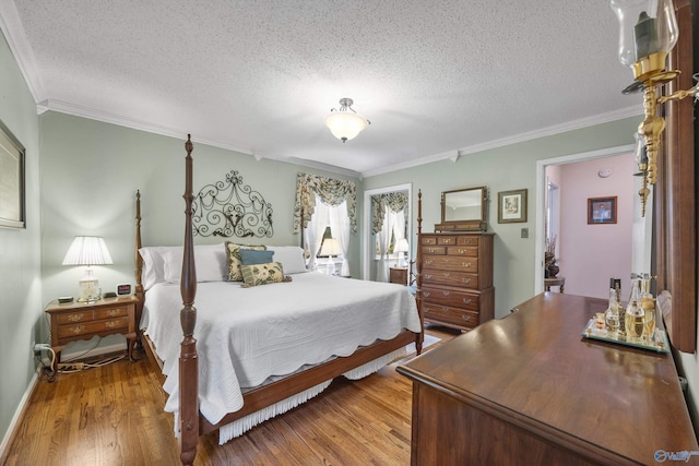 bedroom featuring ornamental molding, a textured ceiling, and hardwood / wood-style floors