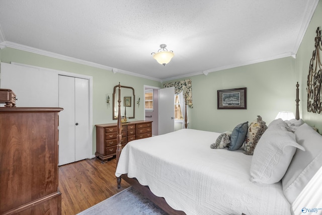 bedroom featuring ornamental molding, a closet, dark hardwood / wood-style floors, and a textured ceiling