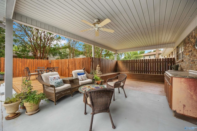 view of patio / terrace featuring an outdoor living space, a wooden deck, and ceiling fan