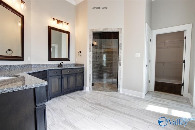 bathroom featuring walk in shower and vanity