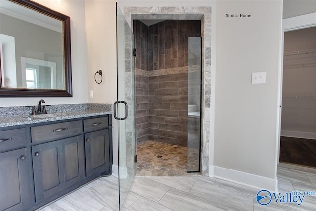 bathroom with vanity and a shower with door