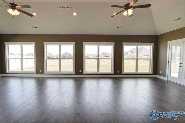 empty room with plenty of natural light, dark wood-type flooring, high vaulted ceiling, and ceiling fan